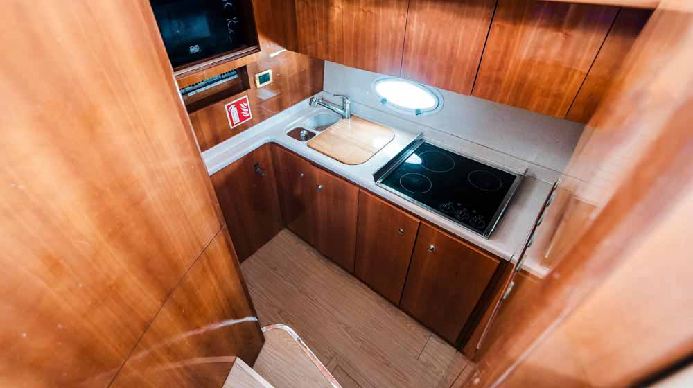 yacht galley with induction cooktop, microwave, storage cupboards